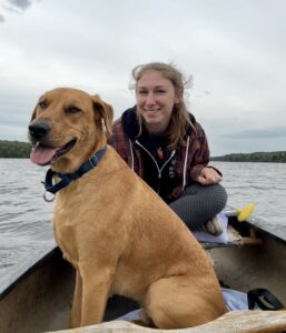 Woman with dog on canoe