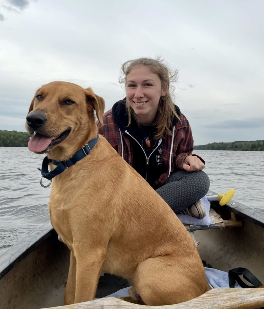 Woman with dog on canoe