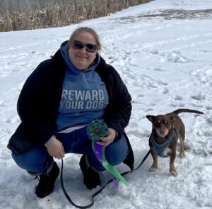 Woman posing with dog in snow