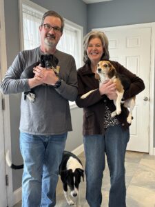 Family with puppy and adult dogs