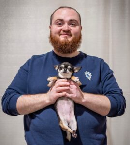 Micah holding his adorable pup
